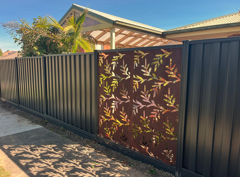 Colorbond fence with decorative privacy screen and sleepers installed in Beaconsfield Melbourne