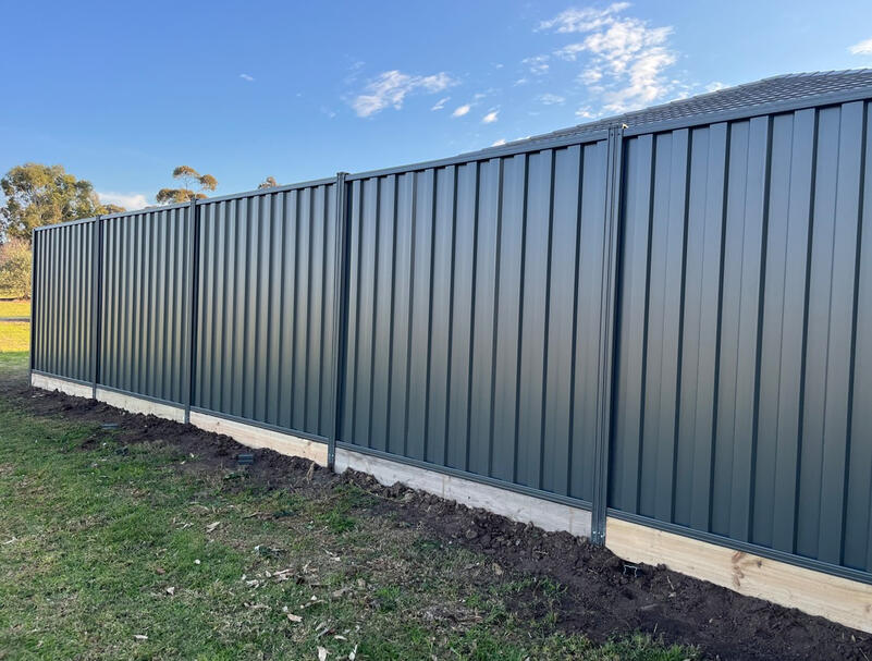 Colorbond fence in Monument colour with timber sleepers installed in Clyde Melbourne