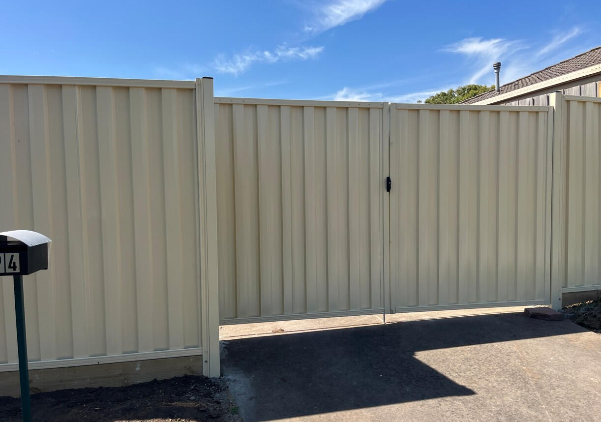Colorbond fence and double gates in Domain colour with timber sleepers installed in Cranbourne Melbourne