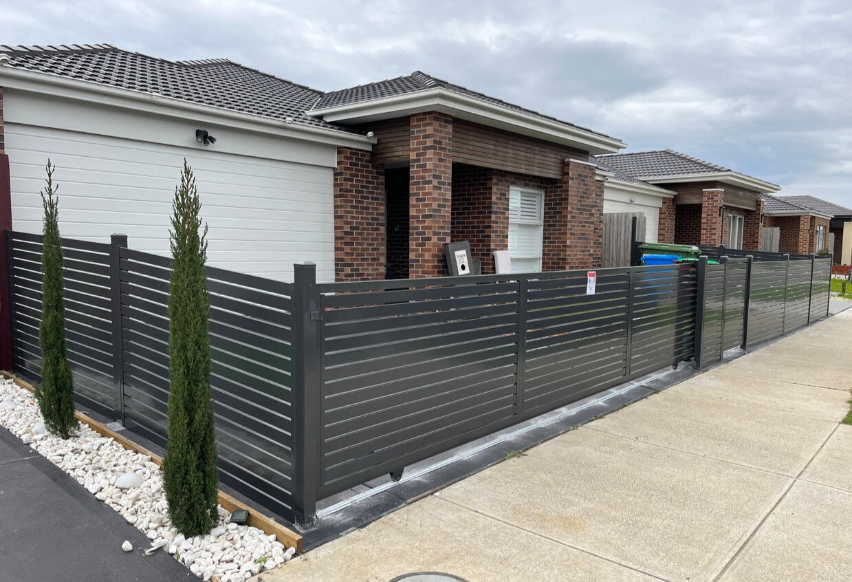 Aluminium Slat Fence & Gate Cranbourne East – Monument aluminium slat fence and sliding gate in Monument colour installed in Cranbourne East Melbourne